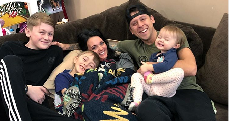 Brittney posing with her husband and children